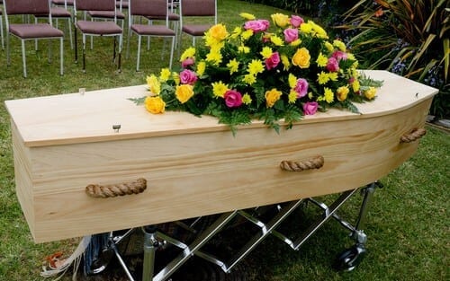 coffin outside with flowers