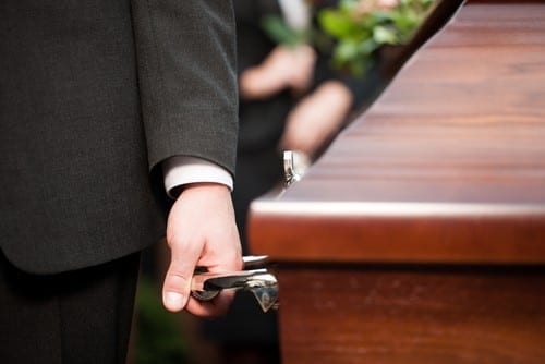 man holding coffin